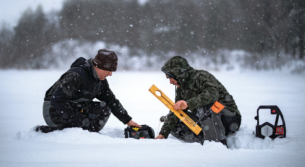 Ice anglers setting up an ice fishing tip-up