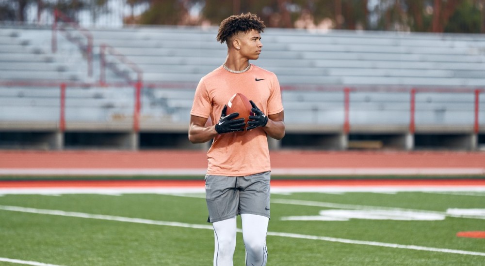 football player holding football