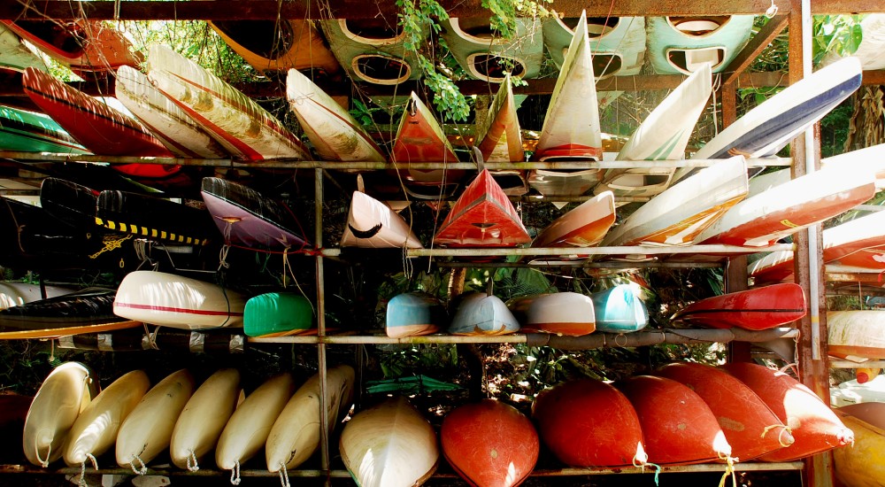 many kayaks stored on a rack