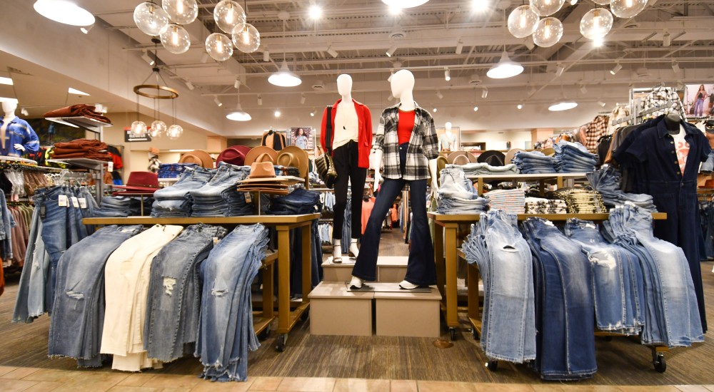 Womens fashion clothing on display on mannequins, racks, and shelves