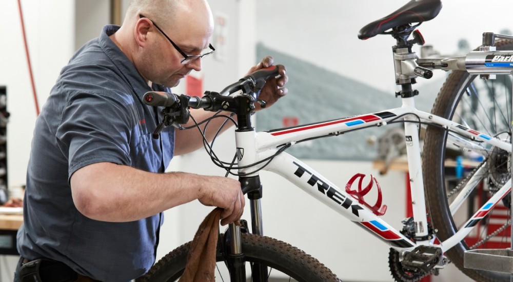 a scheels bike repair associate working on a bike