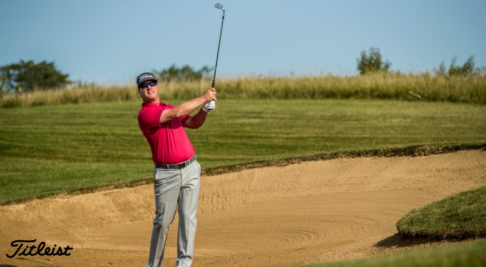 Golfer using a sand wedge in a sand trap