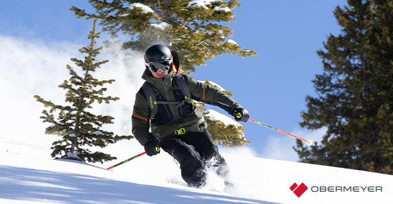 a man wearing a ski jacket while skiing