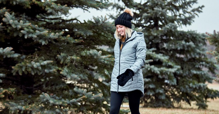 a woman wearing a parka while walking