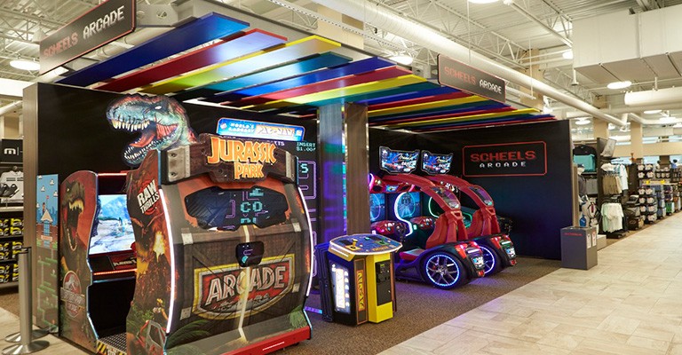 https://scheels.scene7.com/is/image/Scheels/768px-Wichita-Attractions-Arcade?wid=768&hei=400