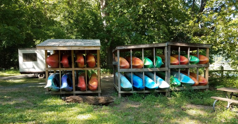 kayaks stored outside on rack