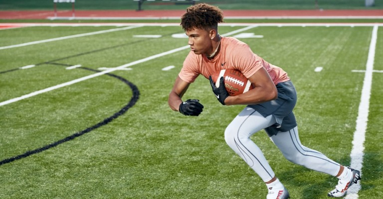 football player holding a football