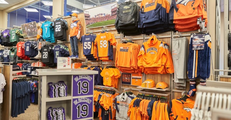 Denver broncos jerseys and apparel on a display wall