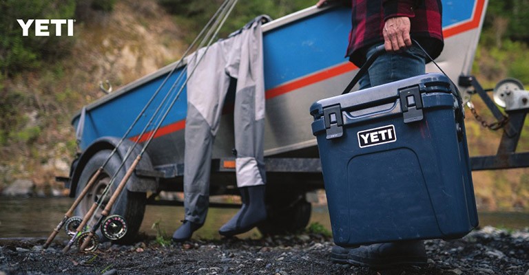 A fisherman using a yeti cooler for fishing