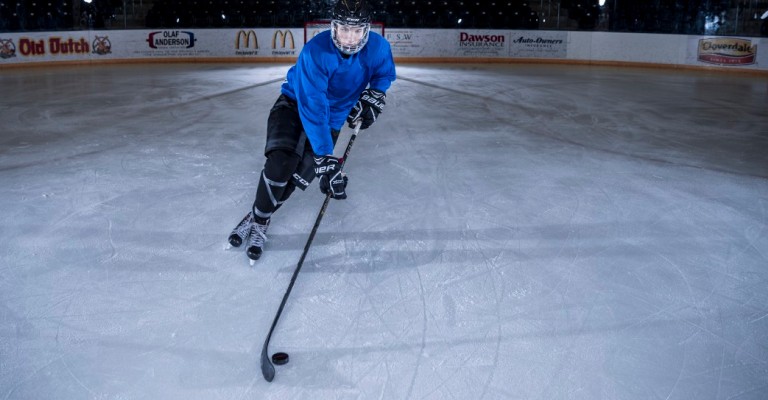 a player skating with a hockey stick