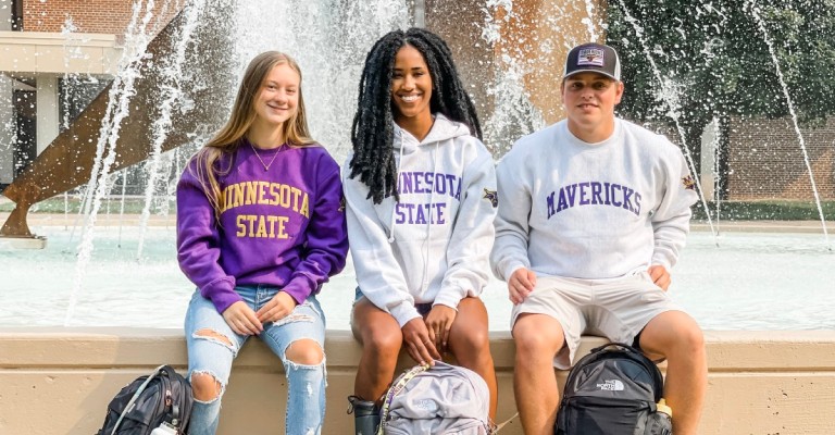 three college students wearing MSU mavericks sweatshirts