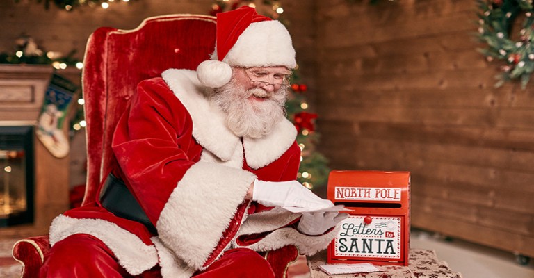 Santa Claus reading his letters