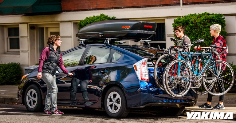a hitch bike rack with bikes and three people
