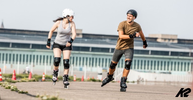 two teenagers rollerblading together