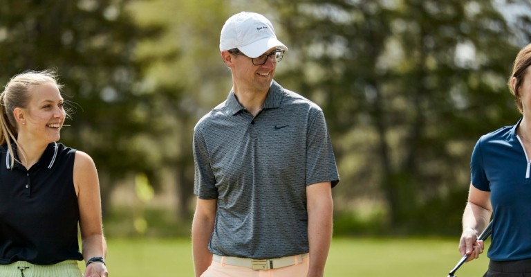 a dad wearing golf clothing on the course