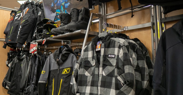 a variety of snowmobile gear in a scheels location
