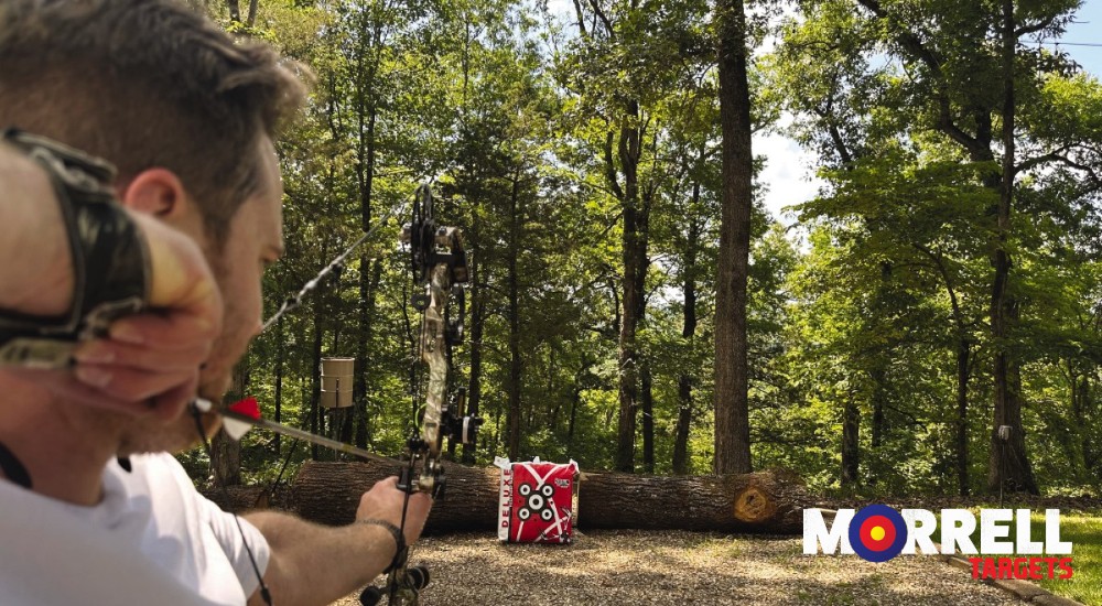 Hunter shooting a bow at a target