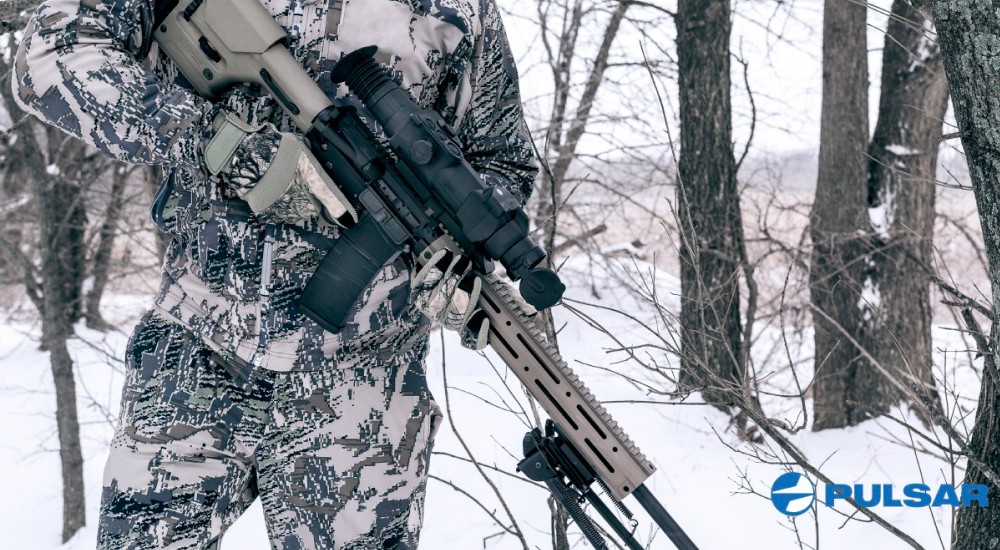 Hunter holding a thermal rifle scope.