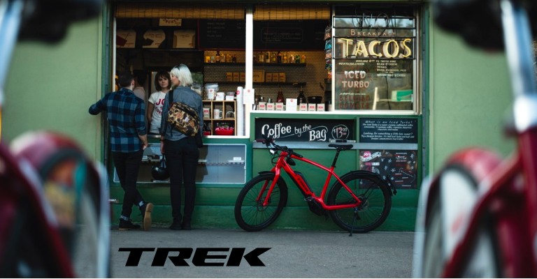 Two people using a bike lock when not riding their bike