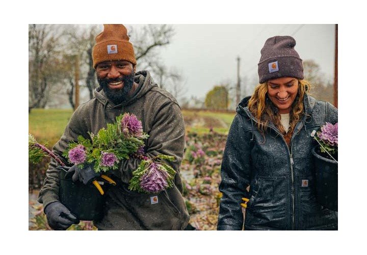 Two adults panting flowers in the rain. 