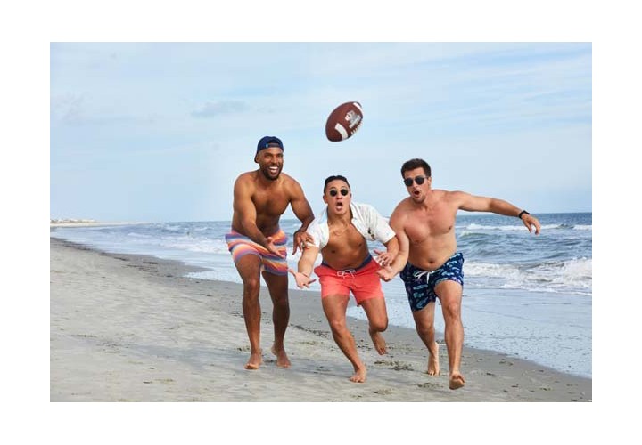 Men playing football on the beach