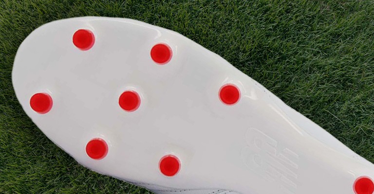the outsole of a firm ground soccer cleat