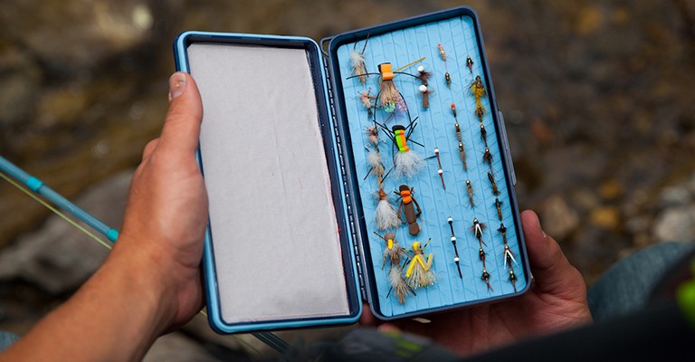 fly box with flies that are needed for fly fishing