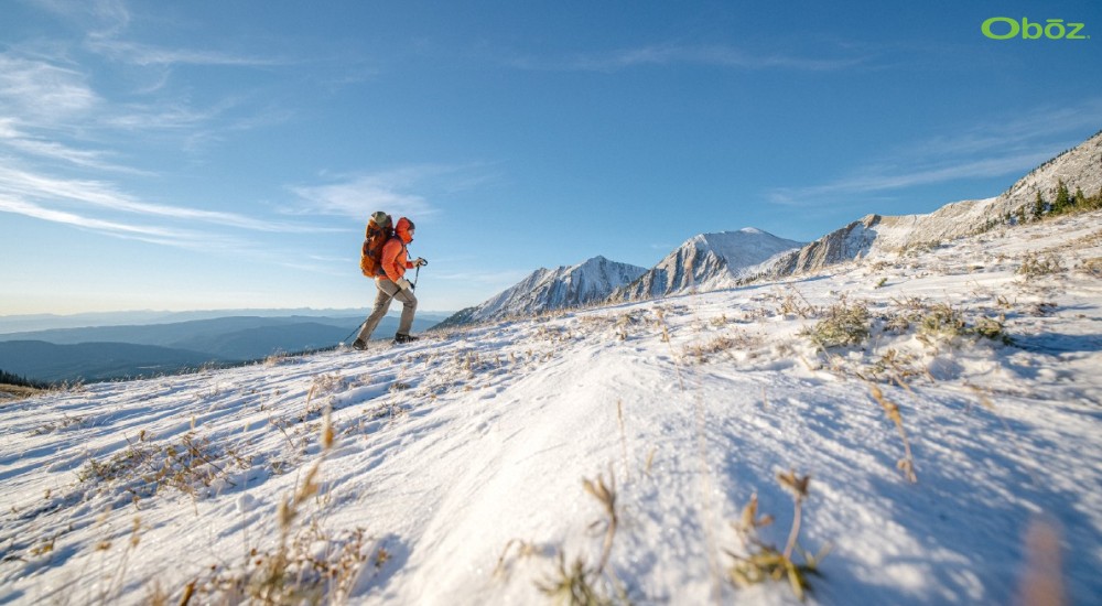 Hiker trekking up snowy mountains