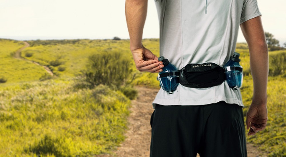 a man wearing a running water belt on him outdoor run
