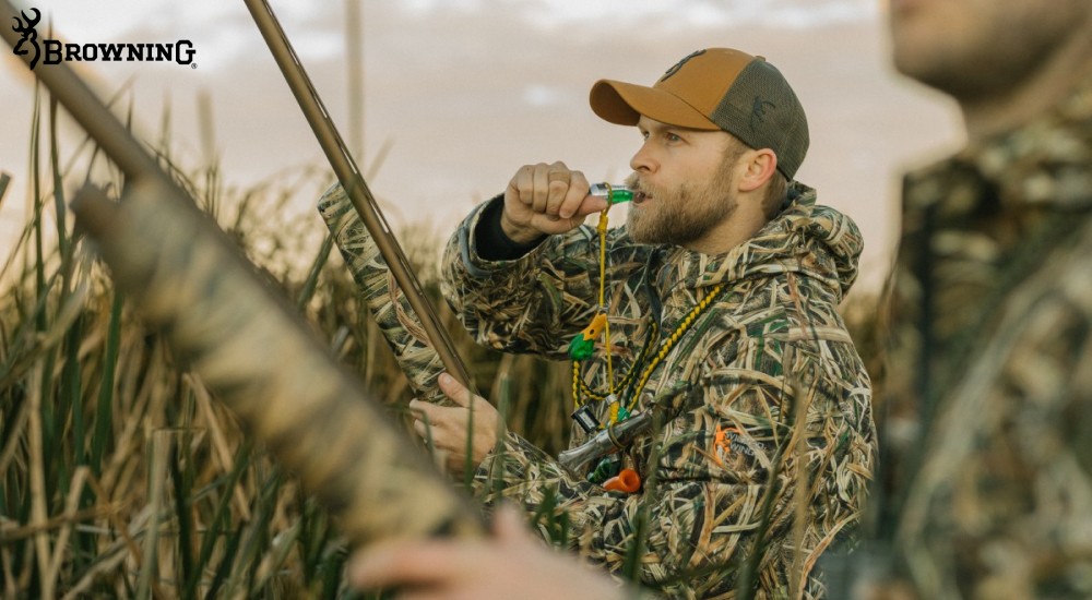 Hunter holding a browning wicked wing shotgun using a waterfowl call