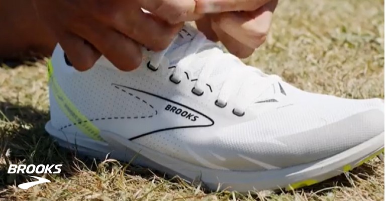 Cross country runner lacing up cross country spikes
