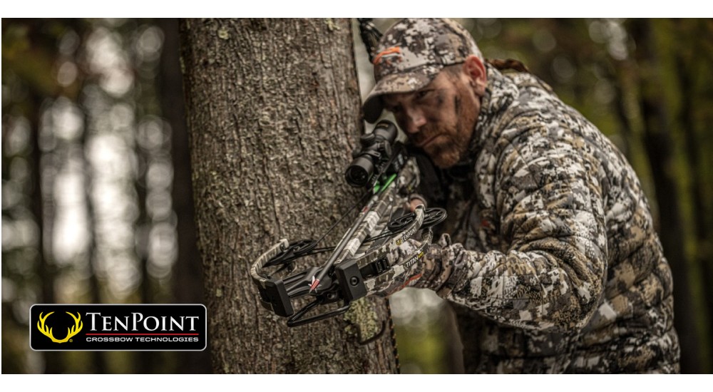 Man Hunting with a crossbow in a tree 