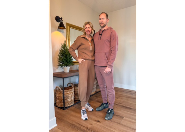Man and women standing in athleisure outfits