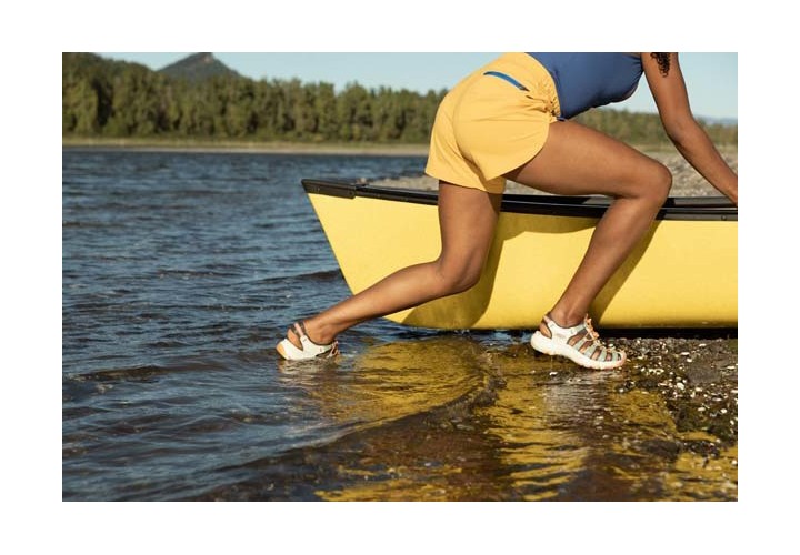 Women pushing kayak in water
