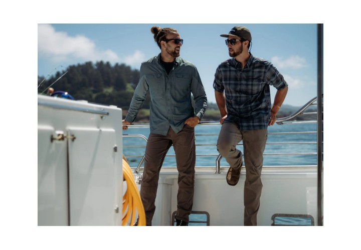 Two men wearing Kuhl Silencr pants Stiefel on a fishing boat talking