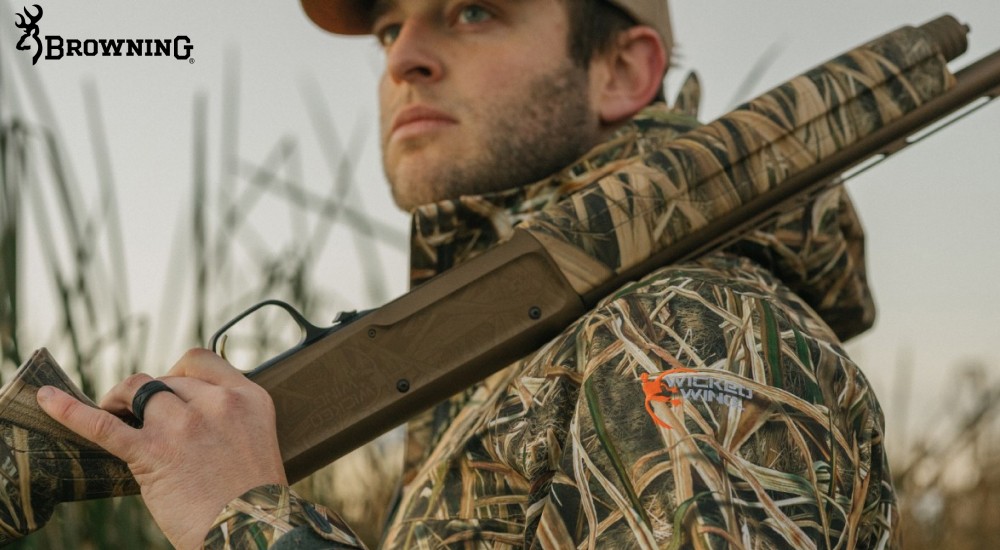 a hunter holding a maxus wicked wing shotgun