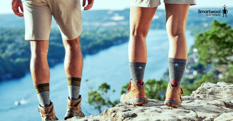 two people standing on a rock wearing smartwool hiking socks