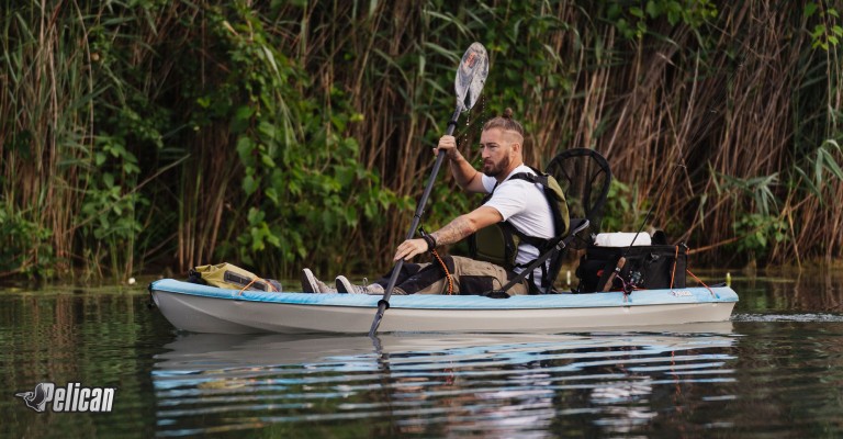 guy kayaking in pelican kayak