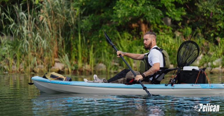 a man sitting on a sit-on-top kayak
