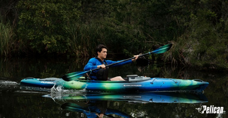man sitting in a sit-in kayak
