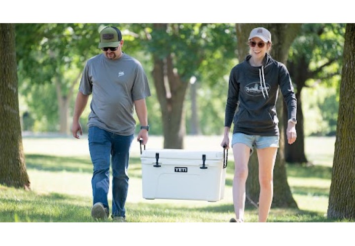 Two people wearing and carrying PF logoed gear