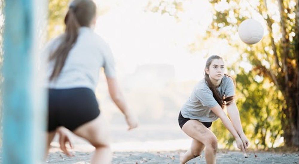 partners practicing volleyball outside