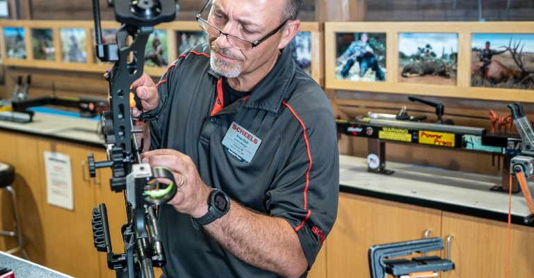 Archery technician working on a bow