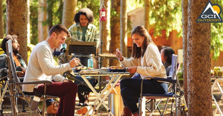 A campsite dinner table with GCI Outdoor chairs