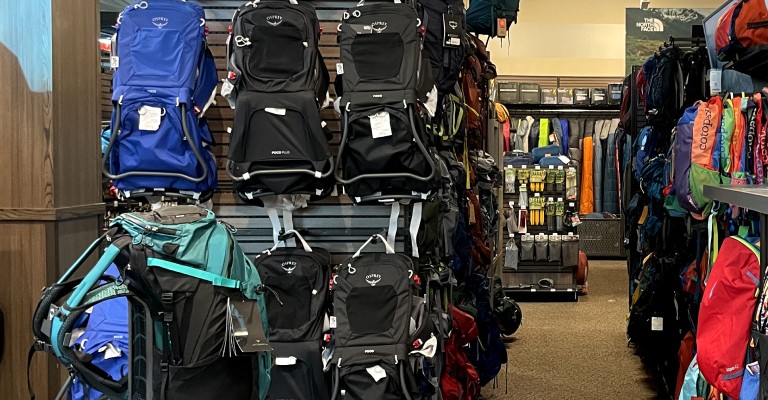 a wall of backing packs at scheels