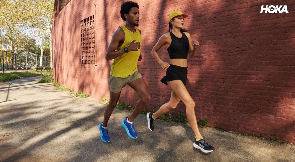 two runners wearing Taille hoka running shoes