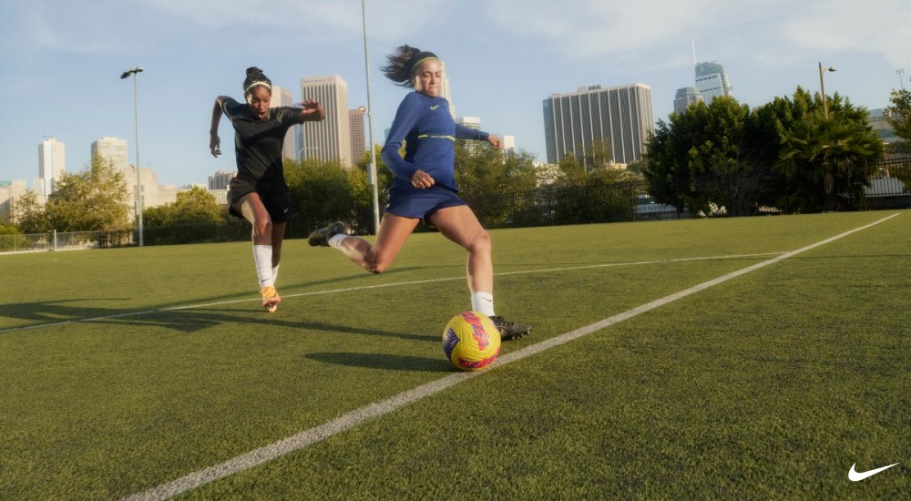 two players playing soccer on a field