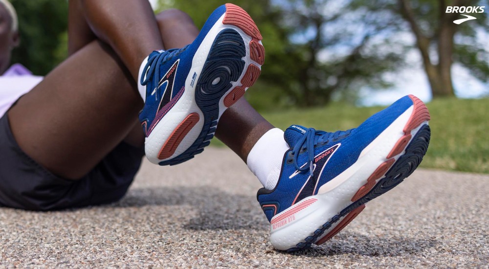 a woman wearing brooks stability running shoes