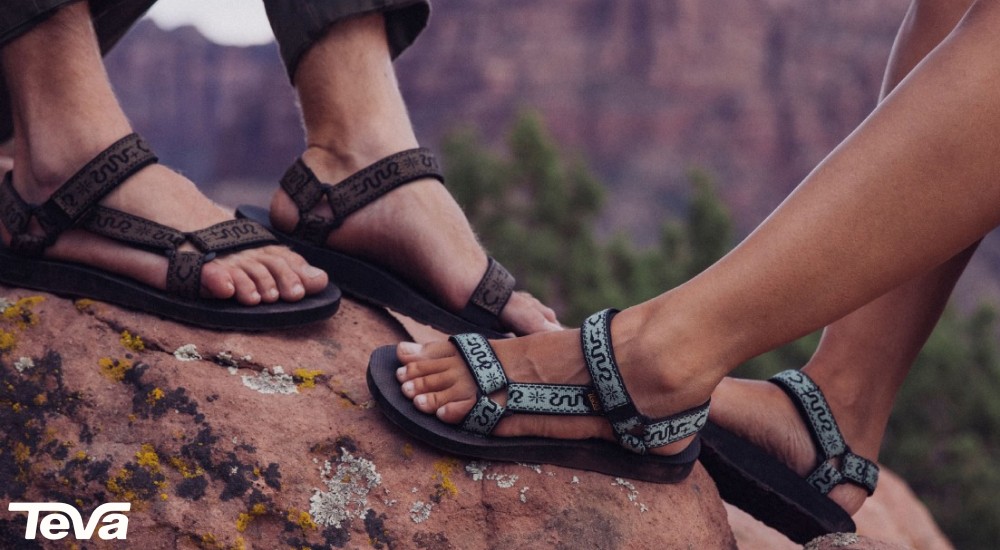 a man and woman wearing teva sandals