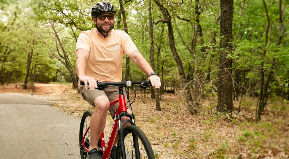 a man wearing sunglasses while riding his bike